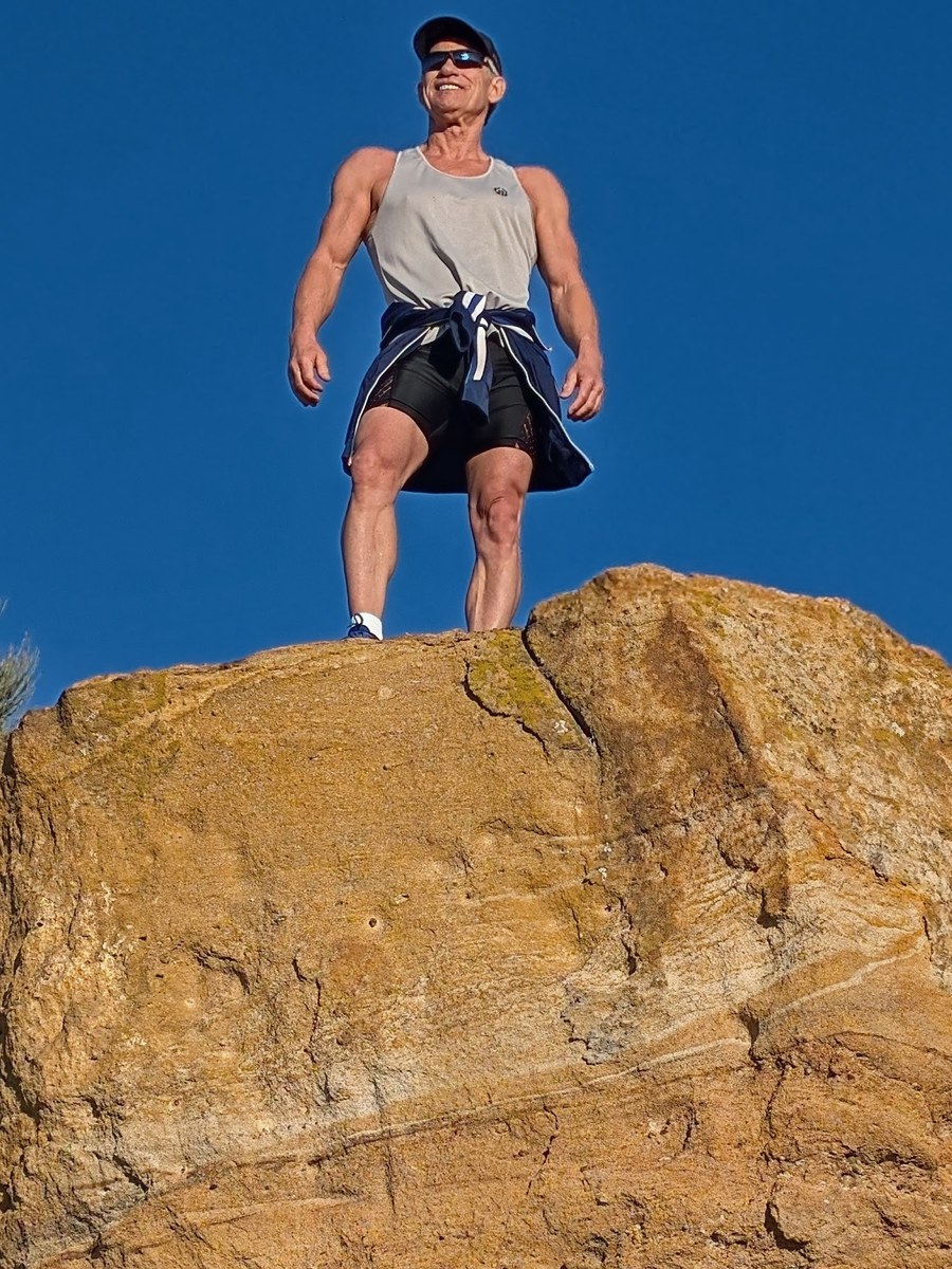 Lex at 65 on the rock — rebuilt, plant-powered